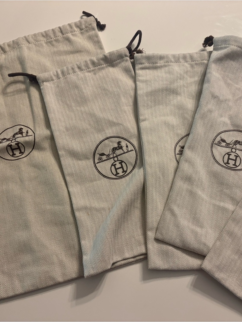 4 Hermes shoe pouches and 1 medium bag bag